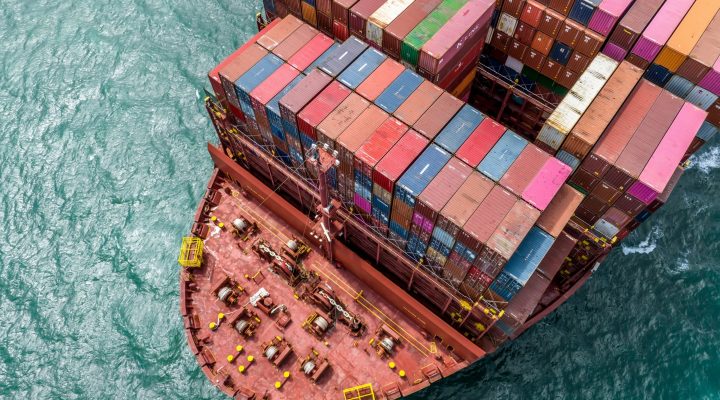 Aerial view of a container ship’s stern showing mechanical deck and shaft area at sea